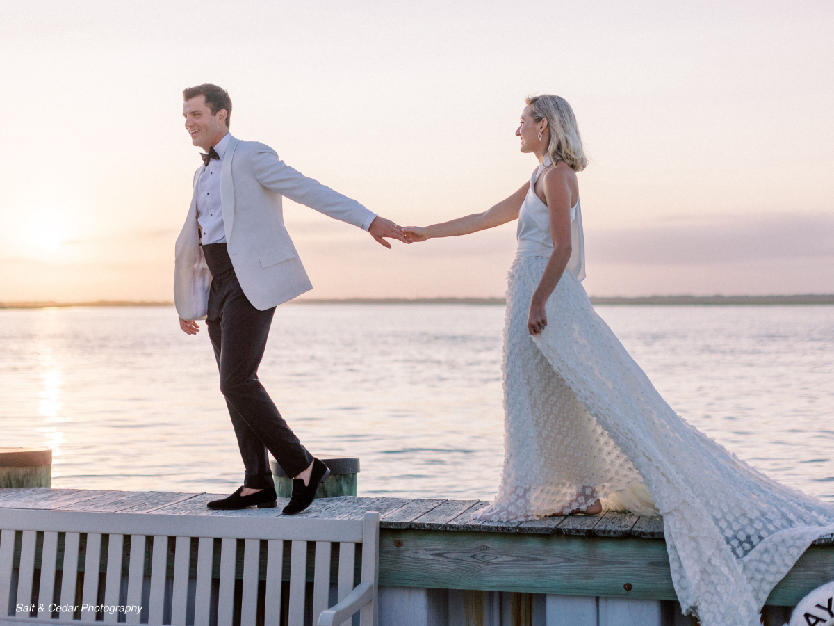 Wedding-couple-walking-on-dock-at-sunset-WEDDING-&-EVENTS-Outside-Sunset-Avalon-Yacht-Club