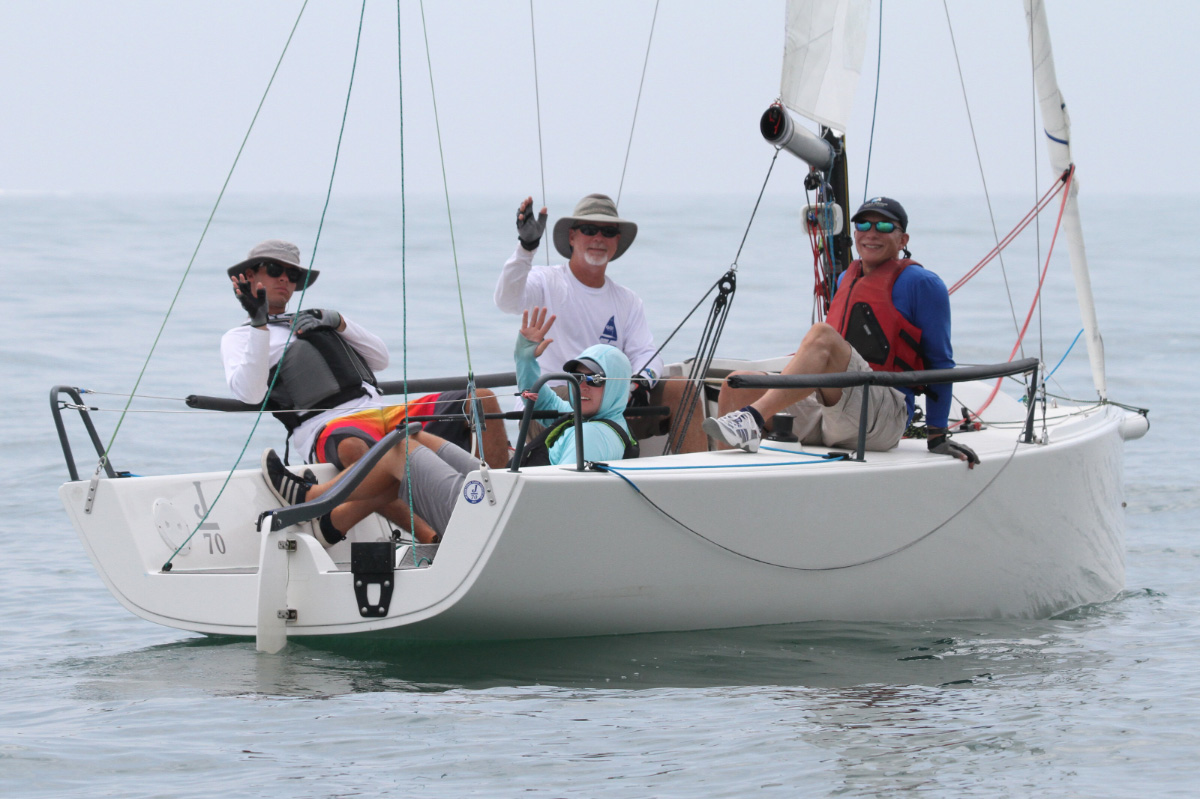 Sailboat-racing-crew-waving-on-the-water-ADULT-SAILING-Avalon-Yacht-Club